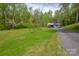 A large grassy lot with mature trees features a long driveway leading to a detached garage at 1009 Catawba Valley Se Blvd, Hickory, NC 28602