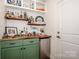 Charming bar area with green cabinets, a wooden countertop, a beverage fridge, and decorative shelving at 104 Trellis Ln, Troutman, NC 28166