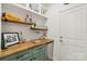 A bar area with butcher block counters, custom storage, and mini-fridge at 104 Trellis Ln, Troutman, NC 28166