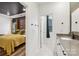 View of a full bathroom featuring modern finishes, next to a bedroom with yellow accents at 104 Trellis Ln, Troutman, NC 28166