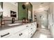 A modern bathroom showcases a double vanity with black fixtures, a glass shower, and elegant finishes for a spa-like experience at 104 Trellis Ln, Troutman, NC 28166
