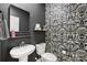 Stylish half bath featuring a black and white patterned wall and modern fixtures at 104 Trellis Ln, Troutman, NC 28166