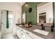 A stylish bathroom featuring a double vanity, black fixtures, a grasscloth accent wall, and marble floors at 104 Trellis Ln, Troutman, NC 28166