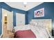 Comfortable bedroom features blue walls, a cozy bed, and a convenient closet at 104 Trellis Ln, Troutman, NC 28166