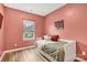 Cozy bedroom featuring a daybed, wood floors, and a window providing natural light at 104 Trellis Ln, Troutman, NC 28166