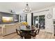 Bright dining area showcasing modern lighting and backyard access, creating a welcoming space at 104 Trellis Ln, Troutman, NC 28166