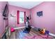 An exercise room featuring an elliptical machine, weights, yoga mats, and pink walls for an inspiring workout space at 104 Trellis Ln, Troutman, NC 28166