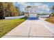 This beautiful home boasts a long driveway and a spacious front yard with a white fence at 104 Trellis Ln, Troutman, NC 28166