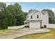 Beautiful two-story home featuring a long driveway and well-manicured lawn at 104 Trellis Ln, Troutman, NC 28166
