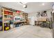 Spacious garage featuring storage shelves and a workspace, providing ample room for projects and organization at 104 Trellis Ln, Troutman, NC 28166