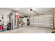 Spacious garage with ample storage, stainless steel refrigerator, and roll up doors at 104 Trellis Ln, Troutman, NC 28166