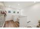 Upstairs hallway with natural light, wood-look floors and whimsical wallpaper at 104 Trellis Ln, Troutman, NC 28166