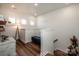Upstairs hallway featuring a blue bench, wood floors, white walls, modern lighting, and neutral decor at 104 Trellis Ln, Troutman, NC 28166
