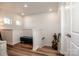 Bright upstairs hallway featuring a blue bench, wood floors, white walls, and modern lighting fixtures at 104 Trellis Ln, Troutman, NC 28166