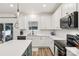 Well-lit kitchen featuring white cabinets, quartz countertops, and stainless steel appliances at 104 Trellis Ln, Troutman, NC 28166