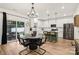 Modern kitchen and dining area with a view to the backyard patio and stainless steel appliances at 104 Trellis Ln, Troutman, NC 28166