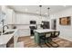 Bright, modern kitchen with stainless steel appliances, stylish island seating, and ample counter space at 104 Trellis Ln, Troutman, NC 28166
