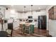 Stylish kitchen with white cabinetry, stainless steel appliances, and a green island at 104 Trellis Ln, Troutman, NC 28166