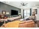 Bright living room featuring a large TV, a cozy sofa, and a ceiling fan for added comfort at 104 Trellis Ln, Troutman, NC 28166
