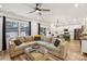 Open-concept living room features a large sectional sofa and connects seamlessly to the modern kitchen at 104 Trellis Ln, Troutman, NC 28166