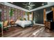Spacious primary bedroom with unique wallpaper, dark ceiling, modern ceiling fan and hardwood-style floors at 104 Trellis Ln, Troutman, NC 28166