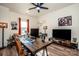 Functional office space featuring a ceiling fan, large desk and multiple monitors, ideal for productivity at 104 Trellis Ln, Troutman, NC 28166