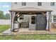Covered patio featuring a grilling station, seating area, and stylish design for outdoor enjoyment at 104 Trellis Ln, Troutman, NC 28166