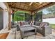 Inviting covered outdoor living area featuring comfortable seating and stylish décor, perfect for relaxation and entertaining at 104 Trellis Ln, Troutman, NC 28166