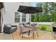 Cozy patio seating area featuring an umbrella-covered table, perfect for outdoor entertaining at 104 Trellis Ln, Troutman, NC 28166