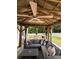 Relaxing covered patio with a ceiling fan, comfortable seating, and an outdoor dining area at 104 Trellis Ln, Troutman, NC 28166