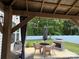 Cozy covered patio with a dining set and fire pit, perfect for outdoor relaxation at 104 Trellis Ln, Troutman, NC 28166