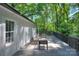 Back deck featuring outdoor seating, string lights and a lovely view of the surrounding trees at 10501 Stonemede Ln, Matthews, NC 28105