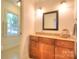 Clean and modern bathroom featuring wooden vanity with granite countertop at 10501 Stonemede Ln, Matthews, NC 28105