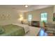 Airy bedroom with bright windows, a comfortable bed, accent chair and decor at 10501 Stonemede Ln, Matthews, NC 28105