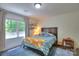 Cozy bedroom with bright window, a wooden bed, and play area at 10501 Stonemede Ln, Matthews, NC 28105