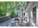 Spacious backyard deck with comfortable seating, string lights, and surrounding trees at 10501 Stonemede Ln, Matthews, NC 28105