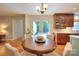 Cozy dining area with wood floors, a round table, and French doors to a patio or backyard at 10501 Stonemede Ln, Matthews, NC 28105