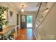 Welcoming entryway with hardwood floors and decorative light fixture at 10501 Stonemede Ln, Matthews, NC 28105