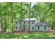 Charming two-story home with a well-maintained lawn and mature trees offering shade and curb appeal at 10501 Stonemede Ln, Matthews, NC 28105