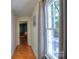 Bright hallway with natural light, wood floors and doorway leading to an outdoor deck at 10501 Stonemede Ln, Matthews, NC 28105