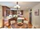 Bright kitchen with an island, stainless steel appliances, stylish lighting, and adjacent dining area at 10501 Stonemede Ln, Matthews, NC 28105