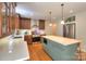 Modern kitchen featuring an island with a quartz countertop, stainless steel appliances, and wooden cabinets at 10501 Stonemede Ln, Matthews, NC 28105