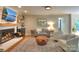Comfortable living room featuring a brick fireplace, hardwood floors, and an open layout at 10501 Stonemede Ln, Matthews, NC 28105