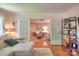 Open living space with hardwood floors, white sofa, and view into another living area through French doors at 10501 Stonemede Ln, Matthews, NC 28105
