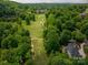 Scenic aerial view of a lush green golf course and a beautiful home nestled among the trees at 110 Cramer Mountain Woods None, Cramerton, NC 28032