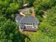 Wonderful aerial view of a luxury home nestled among green trees and featuring an elevated deck at 110 Cramer Mountain Woods None, Cramerton, NC 28032