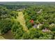 Panoramic aerial view of a stunning home nestled among the trees near a lush green golf course at 110 Cramer Mountain Woods None, Cramerton, NC 28032