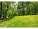 A beautiful, grassy backyard features mature trees and privacy fencing at 110 Cramer Mountain Woods None, Cramerton, NC 28032