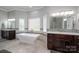 Bright bathroom with a modern tub, stylish vanities, decorative tile, and natural light at 110 Cramer Mountain Woods None, Cramerton, NC 28032