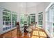 Bright breakfast nook with hardwood floors, a chandelier, and large windows showcasing the outdoor scenery at 110 Cramer Mountain Woods None, Cramerton, NC 28032